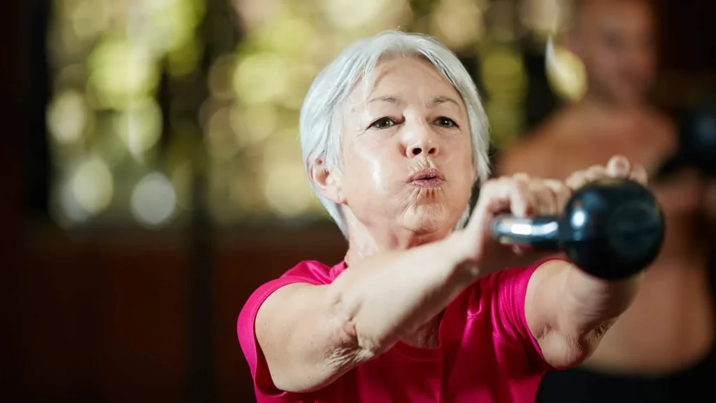 Toning Bingo Wings: Effective Exercises and Tips for Achieving Sleeker Arms 2 Person performing arm exercises with dumbbells Hemel Hempstead
